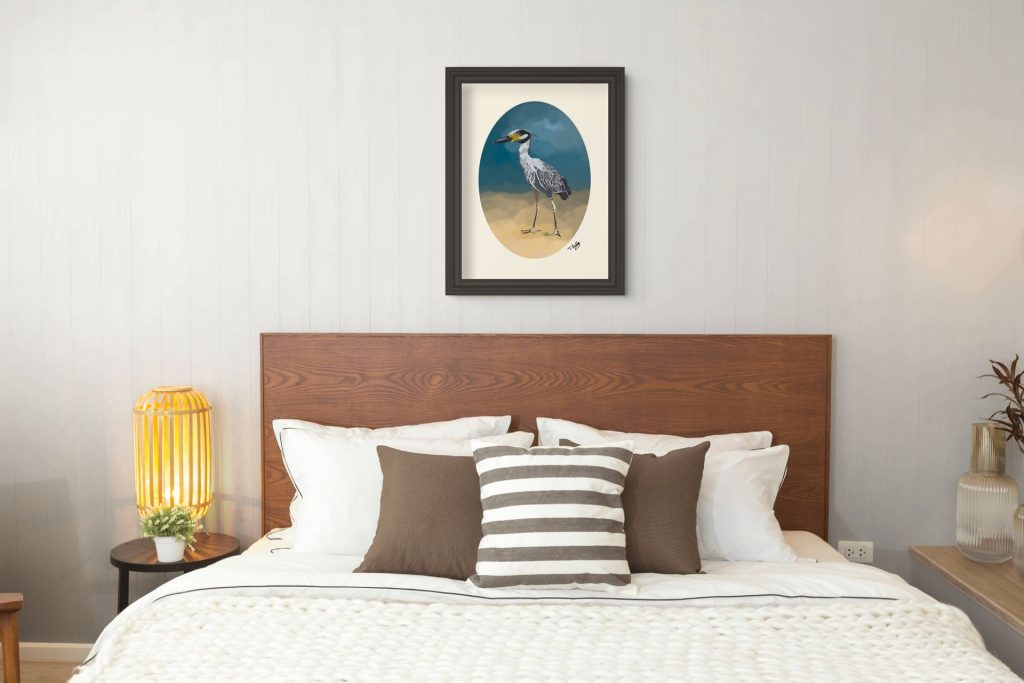 framed heron print on wall